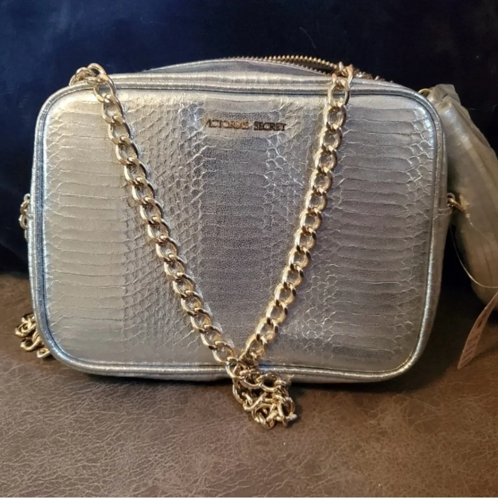 Victoria’s Secret silver snake skin purse with gold chain strap.